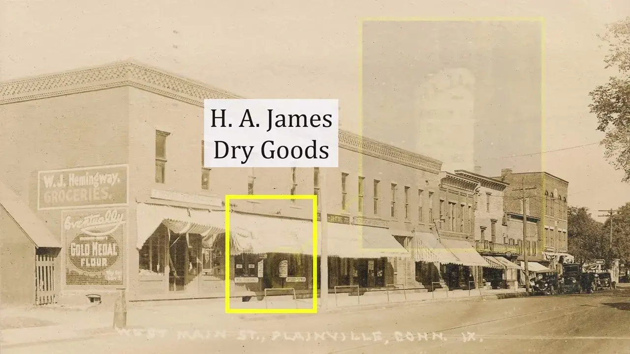 Still from the Historical Society's photo-dating video — a sepia photograph of West Main Street in Plainville, with yellow boxes marking the H. A. James Dry Goods storefront and an awning used as dating clues